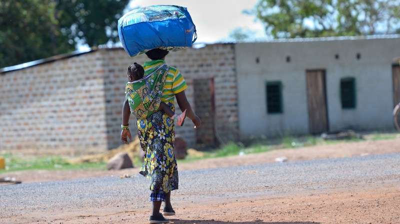 Lusaka mother with baby and luggage